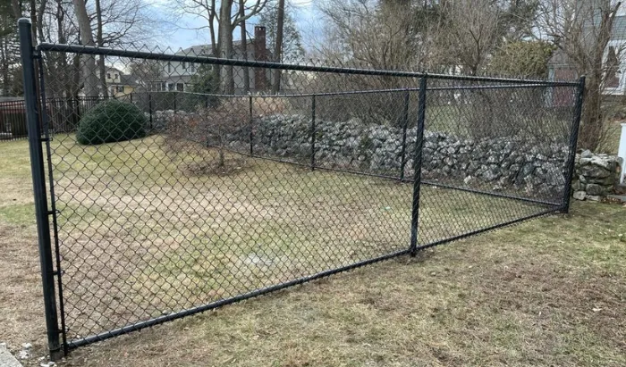 New England Pro Fence contractor providing a free fence estimate to a homeowner in Massachusetts
