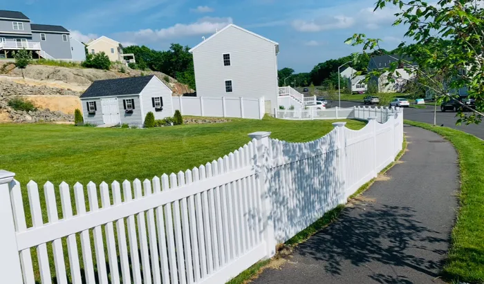 Licensed fence contractor installing a new fence for a homeowner in Massachusetts