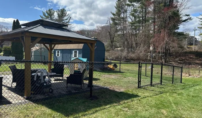 New England Pro Fence crew installing a residential fence in Lowell Massachusetts