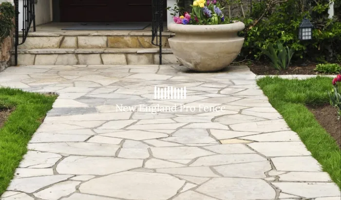 Natural flagstone with irregular shapes for a rustic, organic character. Mortared or dry-laid options available. Perfect for garden paths, side yards, and informal walkways through landscaping. Each flagstone is unique in shape and color, making every path one of a kind. A favorite for cottage and traditional Massachusetts homes.