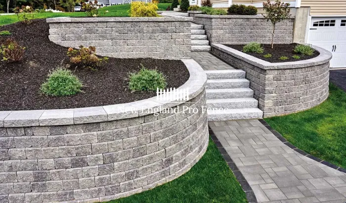 Cut or natural-face granite walls for a formal, structured appearance. Granite is the hardest and most frost-resistant stone available in New England — ideal for property walls, retaining applications, and formal garden features. Extremely durable and virtually maintenance-free. The premium choice for Massachusetts properties that demand lasting quality. Lasts 100 years or more.