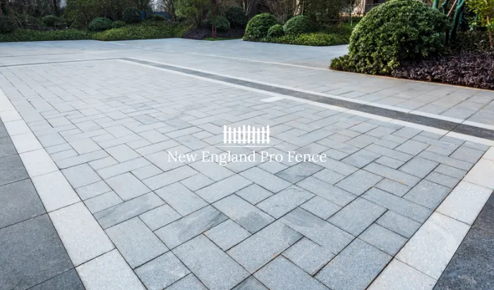 The most popular masonry driveway in Massachusetts. Concrete interlocking pavers in herringbone, basketweave, or running bond patterns. Extremely durable (8,000 PSI) and available in dozens of colors and finishes. Easy to repair by replacing individual pavers — no saw-cutting or re-pouring required.